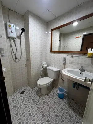 a bathroom with a toilet and a sink and a mirror at Hana apartment in Patong Beach