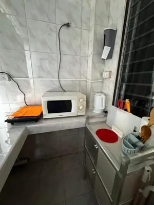 a small kitchen with a microwave on a counter at Hana apartment in Patong Beach