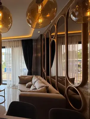 a living room with a couch and some lights at New studio of Bangtao Bellevue Lagoon 213 in Laguna Phuket