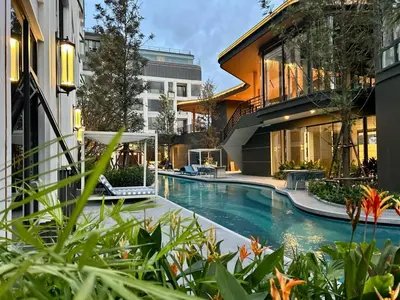 a swimming pool in front of a building at New studio of Bangtao Bellevue Lagoon 213 in Laguna Phuket