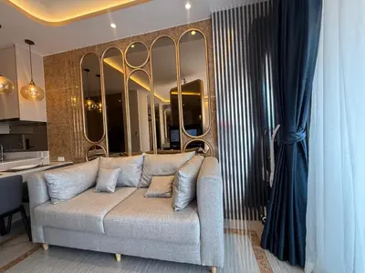 a living room with a couch and some mirrors at New studio of Bangtao Bellevue Lagoon 213 in Laguna Phuket