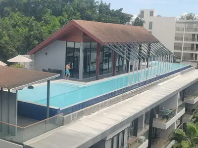 an overhead view of a building with a swimming pool at palmyrah apartment 300 meters from surin beach in Ban Nong Chaeng
