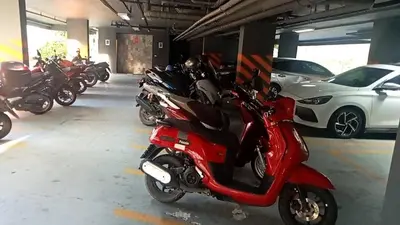 a group of motorcycles parked in a parking garage at palmyrah apartment 300 meters from surin beach in Ban Nong Chaeng