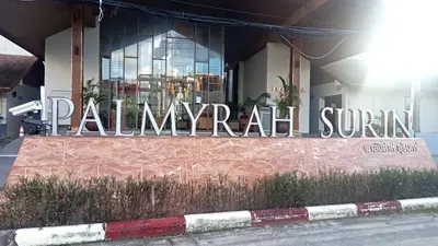 a sign on the side of a building at palmyrah apartment 300 meters from surin beach in Ban Nong Chaeng