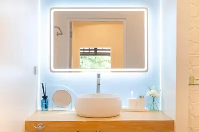a bathroom with a mirror on a wooden table at Stylish Studio with Pool - 8' walk to Rawai Beach - 