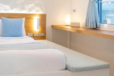 a bedroom with a bed and a window at Stylish Studio with Pool - 8' walk to Rawai Beach - 