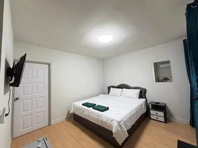 a bedroom with a bed and a television in it at Greenview Room and Restaurant
