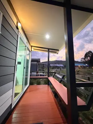 a balcony with a bench on the side of a house at Greenview Room and Restaurant