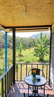 a patio with a table and chairs on a balcony at Greenview Room and Restaurant