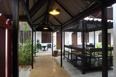 a covered patio with a table and a dining room at Residy Downtown Hotel in Patong Beach