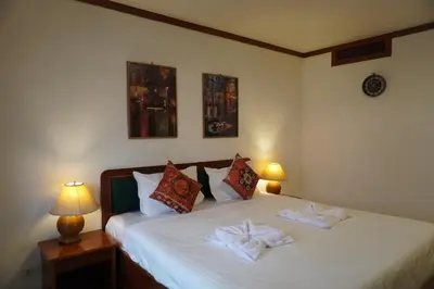 a bedroom with a bed with two towels on it at Residy Downtown Hotel in Patong Beach