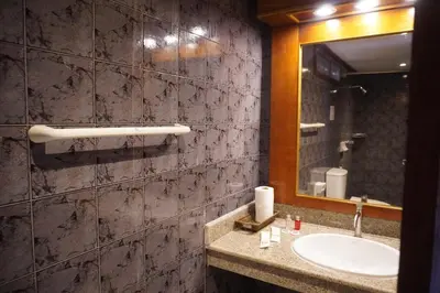 a bathroom with a sink and a mirror at Residy Downtown Hotel in Patong Beach