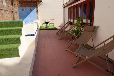 a pair of chairs sitting on a porch with a porch at Residy Downtown Hotel in Patong Beach