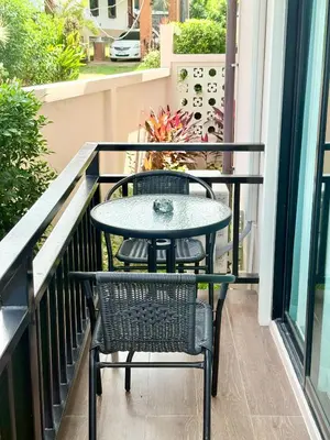 a table and two chairs on a balcony at PS House Bangtao in Bang Tao Beach
