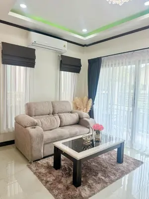 a living room with a couch and a coffee table at PS House Bangtao in Bang Tao Beach