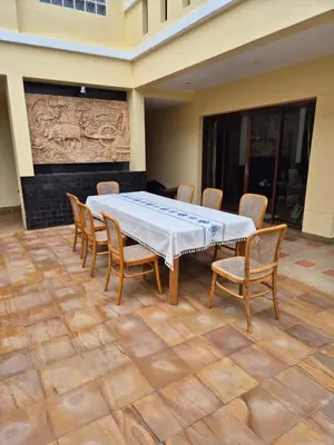 a large table and chairs in a room at 5BR Luxury Villa Bangtao With Staff Phuket in Laguna Phuket