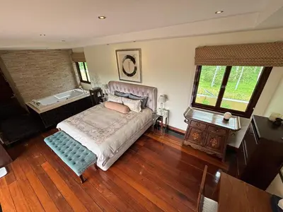 a bedroom with a bed and a wooden floor at 5BR Luxury Villa Bangtao With Staff Phuket in Laguna Phuket