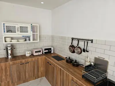 a kitchen with a wooden counter top with appliances at CK House in Patong Beach