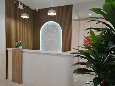 a room with a statue on a counter with a plant at CK House in Patong Beach
