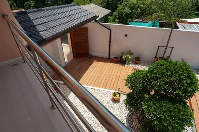 an overhead view of a balcony with a wooden deck at Tilawan Villa by G Estate Phuket in Ban Klang