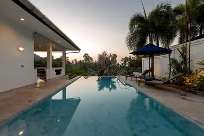 a swimming pool next to a house at 50% Off Baan Angelo 3 Bed Pool Villa Kata Hill in Kata Beach