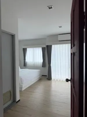 a bedroom with a bed and a large mirror at Jellyfish Residence Patong in Patong Beach