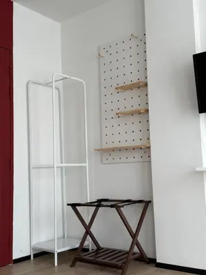 a room with a wooden table and a shelf at Jellyfish Residence Patong in Patong Beach