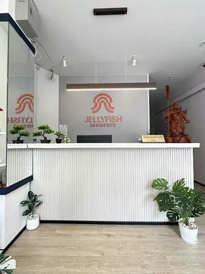 a restaurant with a counter with potted plants on it at Jellyfish Residence Patong in Patong Beach