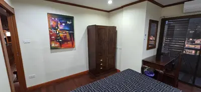 a bedroom with a bed and a dresser and a desk at PATONG TOWER Luxury Large Apartments in Patong Beach