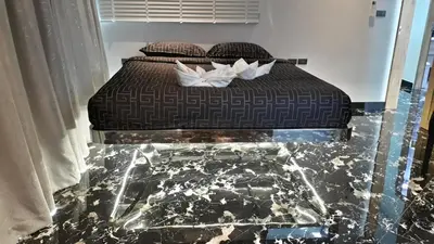 a bed with two pillows on it in a room at PATONG TOWER Luxury Large Apartments in Patong Beach
