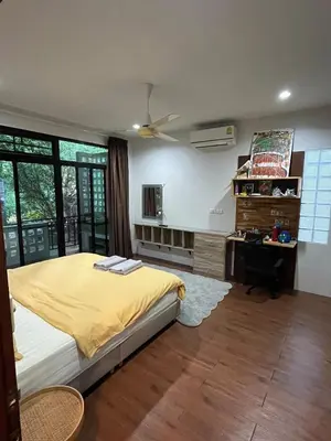 a bedroom with a bed and a desk in it at Rawai Beach Villa in Nai Harn Beach