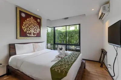 a bedroom with a large bed and a large window at C239 Best Spot Beachfront 1BR Near Top Beaches in Rawai Beach