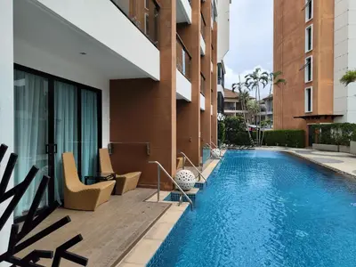 a swimming pool next to a building at 4 Floor - Pool view Studio room at TBHR near Kata beach in Kata Beach