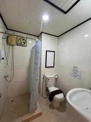 a bathroom with a shower and a toilet and a sink at SVAH Boutique Patong in Patong Beach