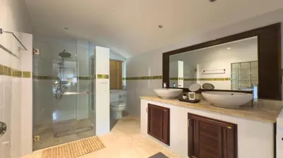 a bathroom with two sinks and a shower at Tropical Poolside Villa - SGB4 in Phuket Town