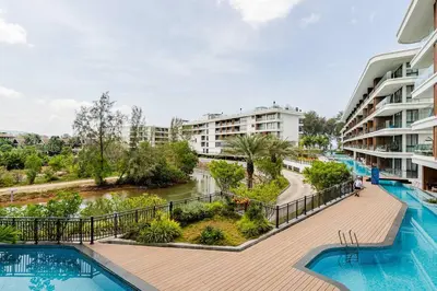a view of the pool at a resort with buildings at Sunshine by Villacarte in Layan Beach