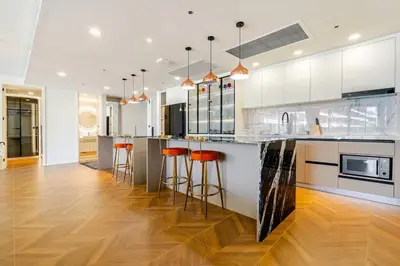 a kitchen with a large island with bar stools at Sunshine by Villacarte in Layan Beach
