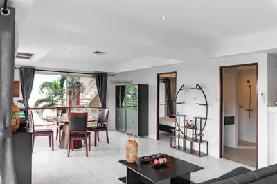 a living room with a couch and a table at Condominium Rawai D1 - near convenience beach, market, gym in Rawai Beach