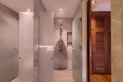 a bathroom with a shower and a walk in shower at Villa Eugenia in Phuket Town