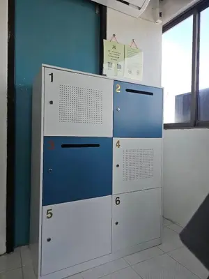 two lockers in a room with a blue wall at MT friendhome&hostel2 in Phuket Town