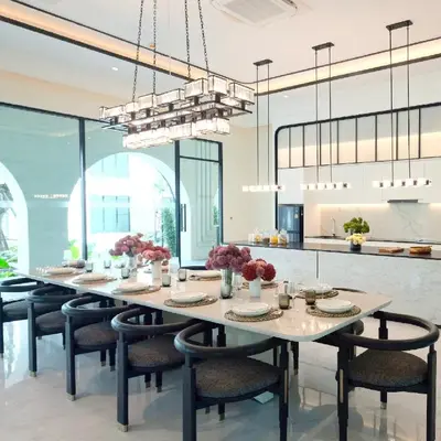 a dining room with a large table and chairs at The Title Legendary Bang Tao Beach in Phuket