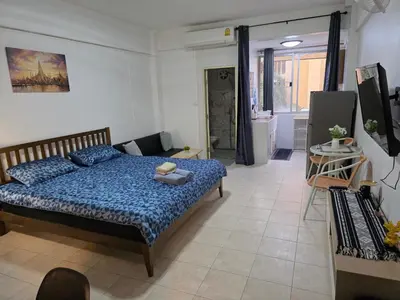 a bedroom with a bed with a blue comforter at Monkey Apartment 38 in Patong Beach