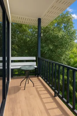 a porch with a bench and a table on it at Chaota Modern House in Ban Ao Makham