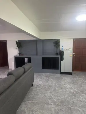 a living room with a couch and a refrigerator at Chaota Modern House in Ban Ao Makham