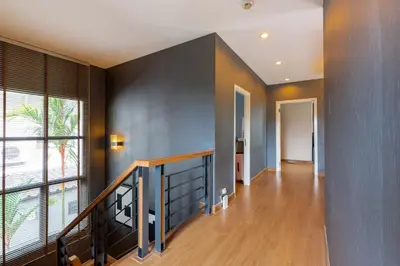 a hallway with a staircase and a large window at The Golden Palm Residence - Kathu - 10 min to Patong Beach in Kathu