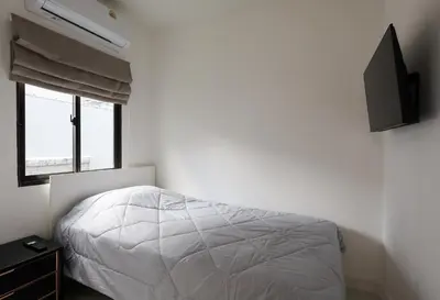 a bedroom with a bed and a flat screen tv at The Golden Palm Residence - Kathu - 10 min to Patong Beach in Kathu