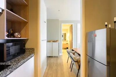 a kitchen with a refrigerator and a dining room at Diamond Condominium Phuket 2BR 5 min to Bangtao beach in Bang Tao Beach