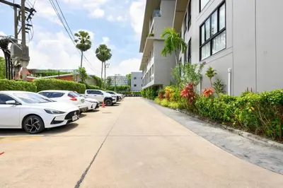 a row of cars parked next to a building at Diamond Condominium Phuket 2BR 5 min to Bangtao beach in Bang Tao Beach