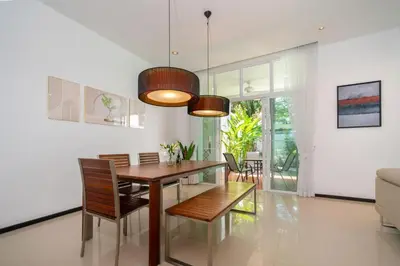 a dining room with a table and chairs at Private pool villa in the heart of Bangtao in Bang Tao Beach