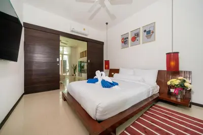 a bedroom with a large white bed in a room at Private pool villa in the heart of Bangtao in Bang Tao Beach